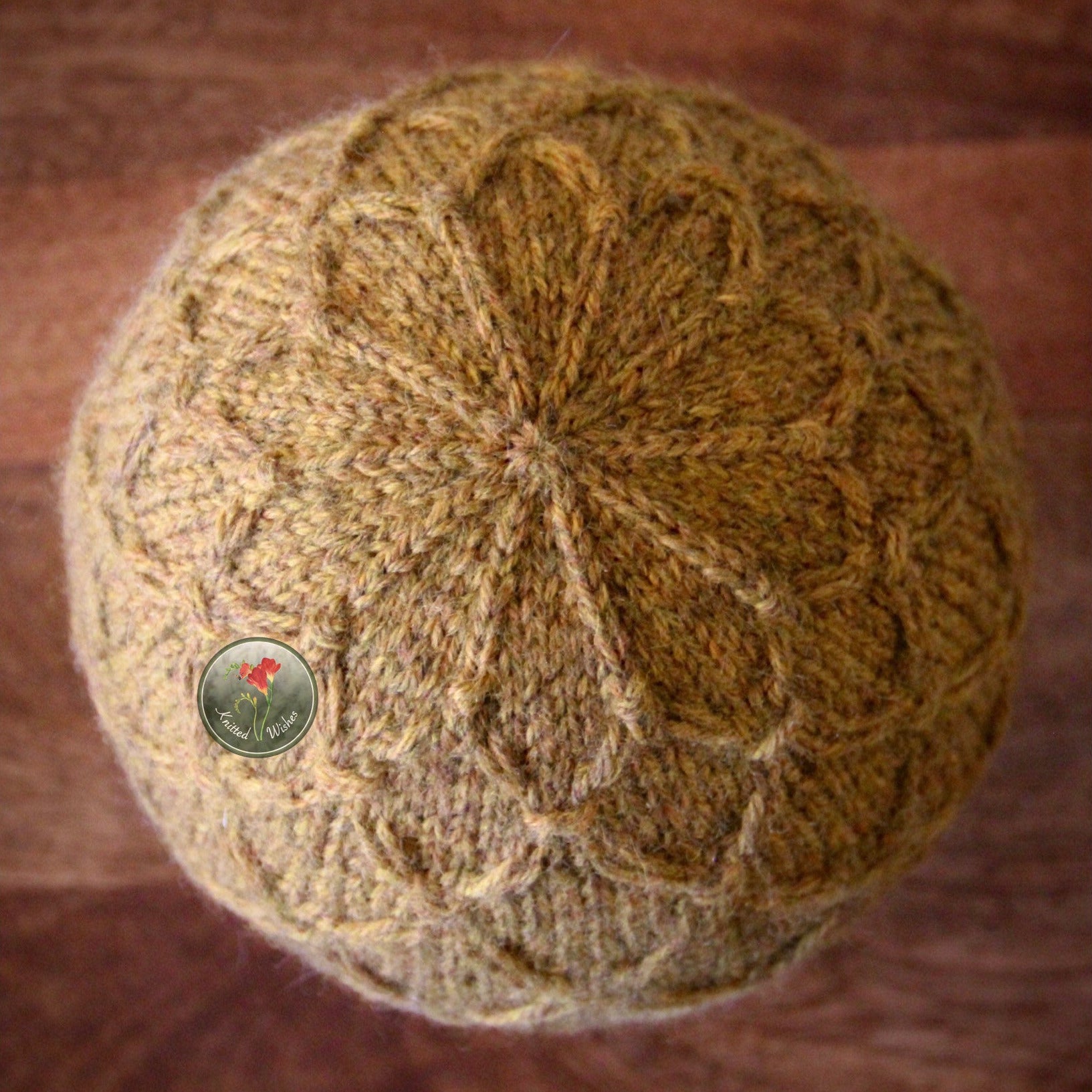 Knitted yellow textured hat on a wooden surface