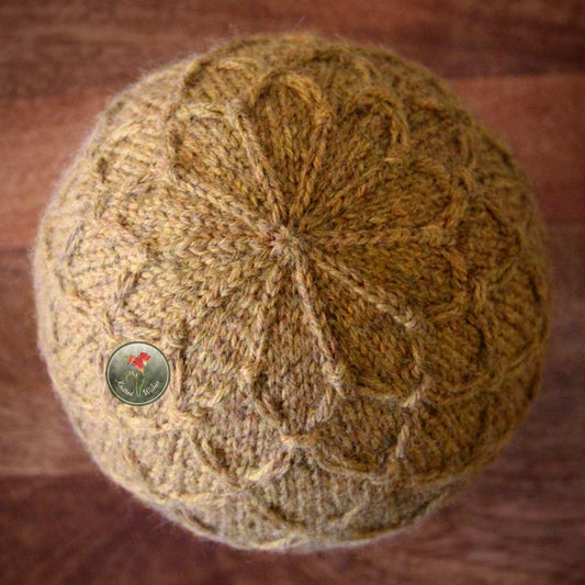 Knitted yellow textured hat on a wooden surface