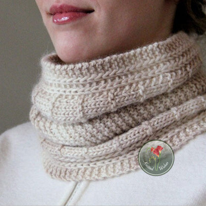 Close-up of a person wearing a knitted textured beige cowl.