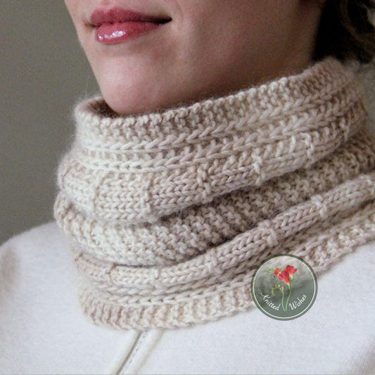 Close-up of a person wearing a knitted textured beige cowl.