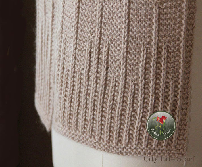 Close-up of a beige textured knitted scarf on a dark background