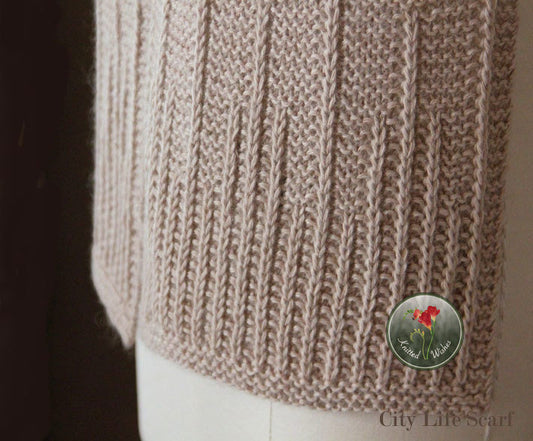 Close-up of a beige textured knitted scarf on a dark background