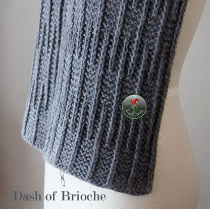 Gray knitted textured scarf on a mannequin