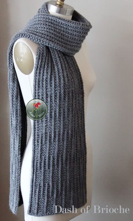 Gray textured knitted scarf on a mannequin with a beige background