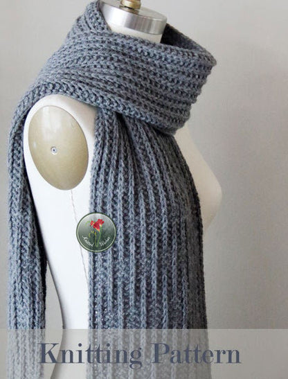 Gray textured knitted scarf on a mannequin  with a label  'Knitting Pattern'.