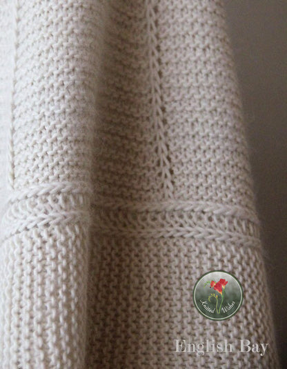 Close-up of a cream textured knitted shawl.