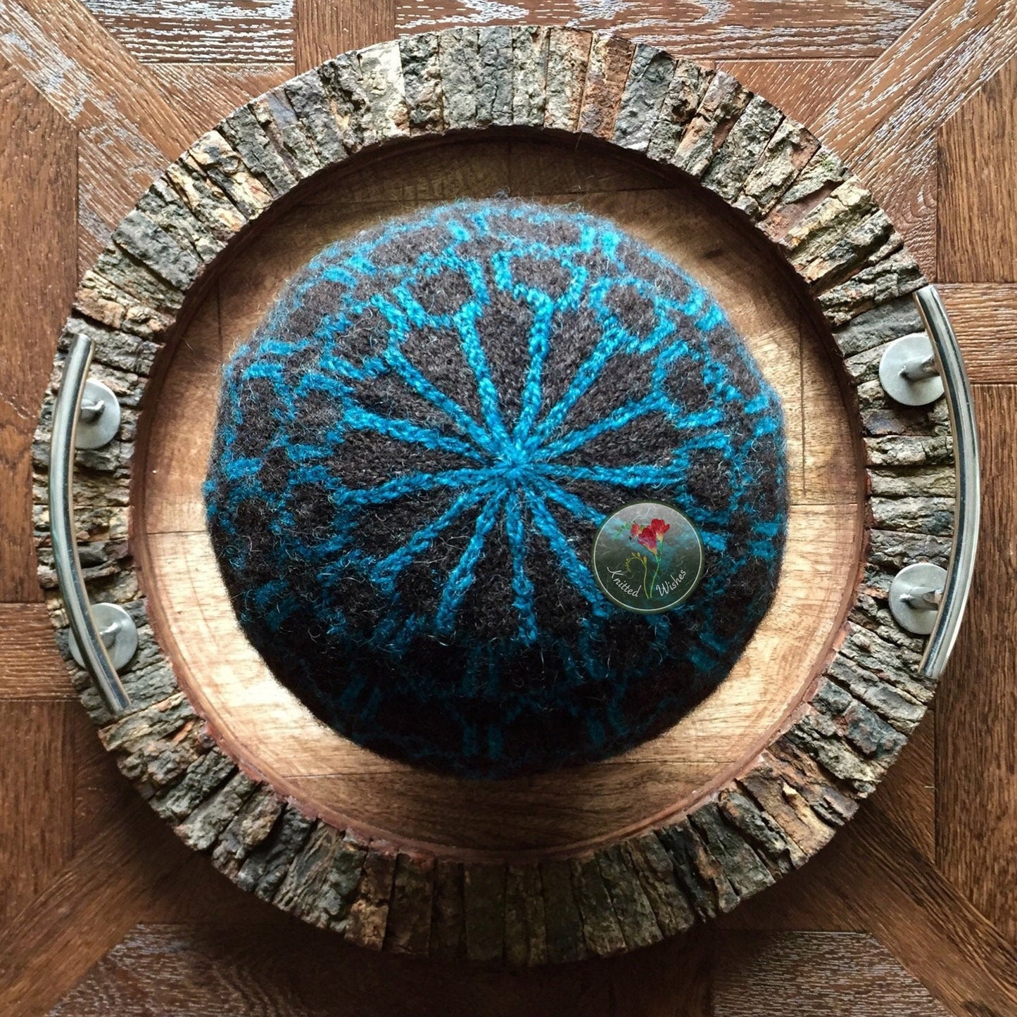 Knitted colorwork beanie on a wooden tray 