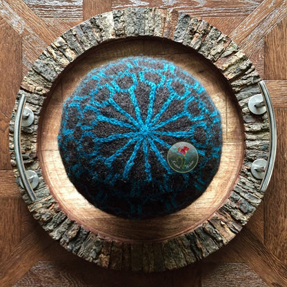 Knitted colorwork beanie on a wooden tray 