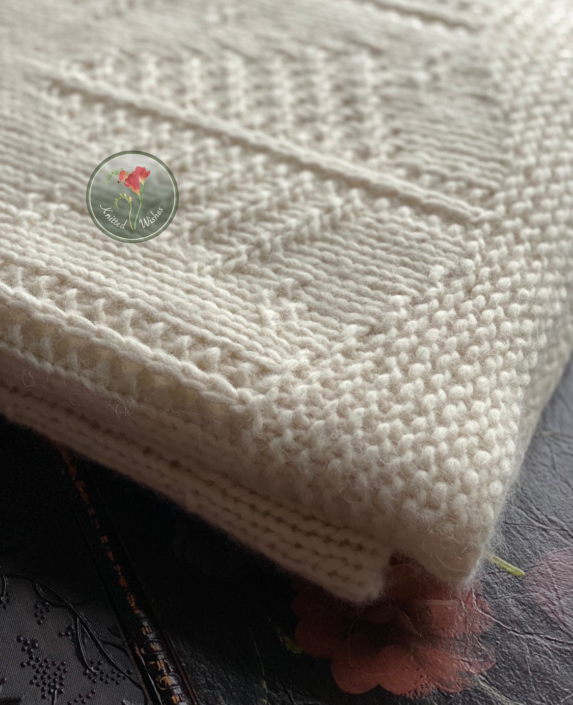 Close-up of a textured knitted white tree blanket.