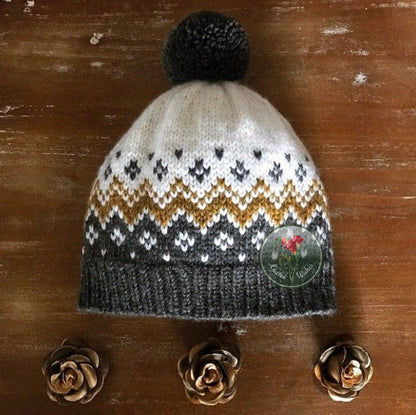 Knitted colorwork hat with a pattern on a wooden surface