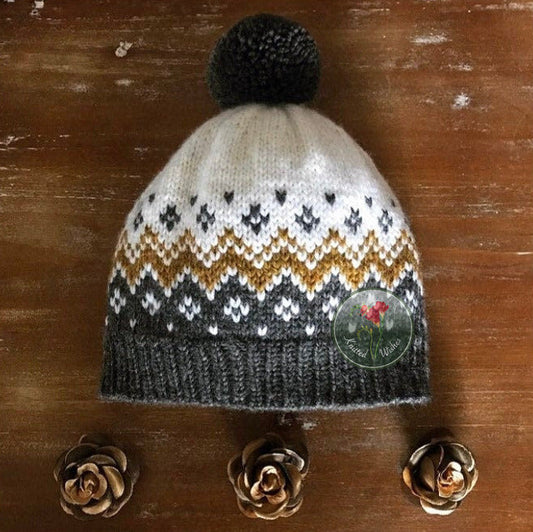 Knitted colorwork hat with a pattern on a wooden surface