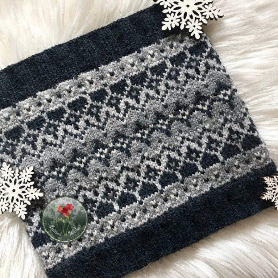 Knitted blanket with a geometric pattern on a white surface