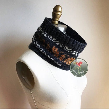 Knitted cowl with an acorn and oak leaf pattern on a mannequin with a brand label in the corner