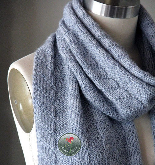 Blue textured knitted scarf on a mannequin.