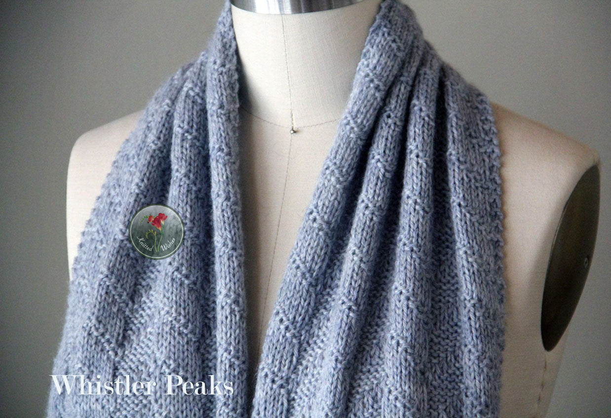 Blue textured knitted scarf on a mannequin.