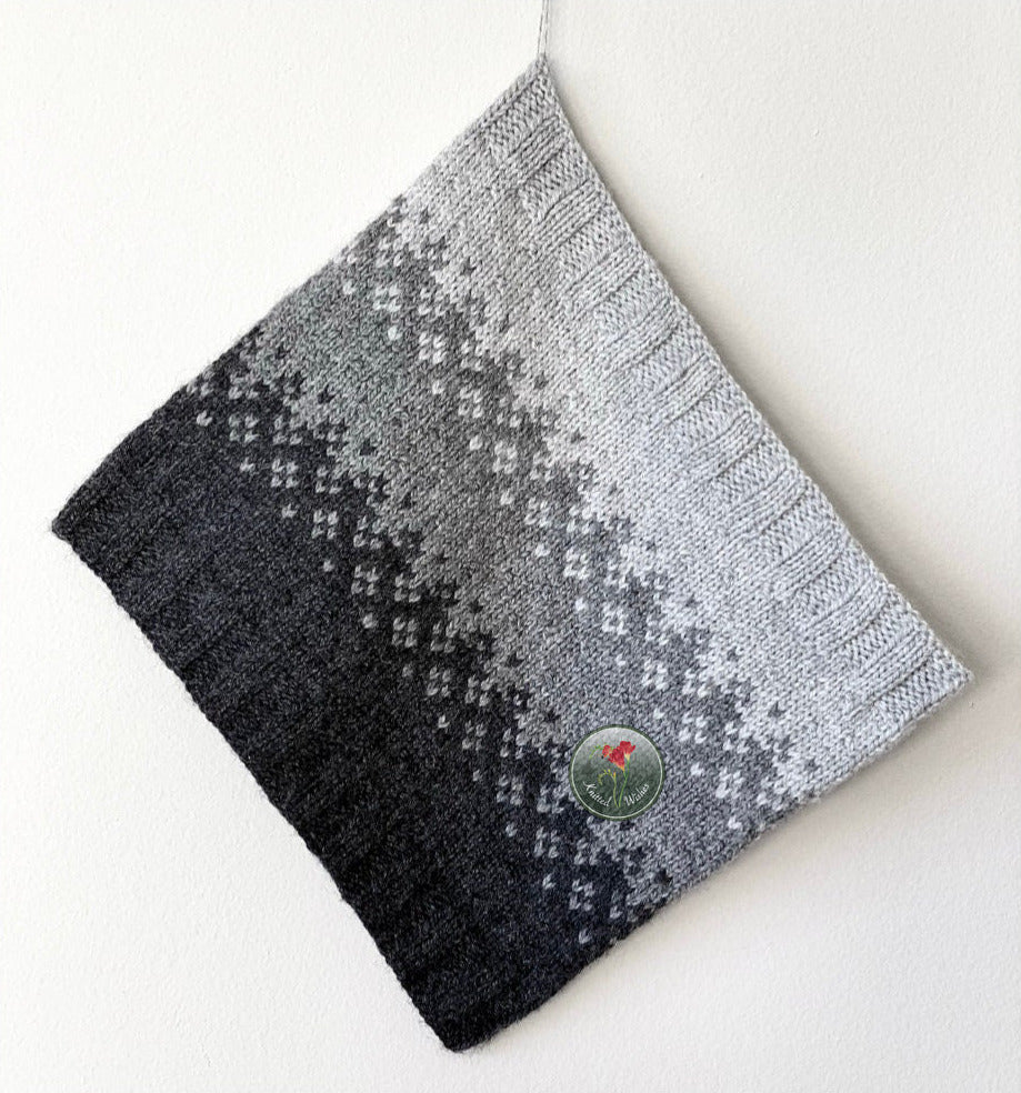 Gradient colorwork cowl with black and gray pattern on a white background