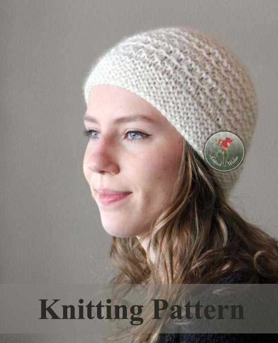 Woman wearing a chunky textured knitted beanie on a plain background